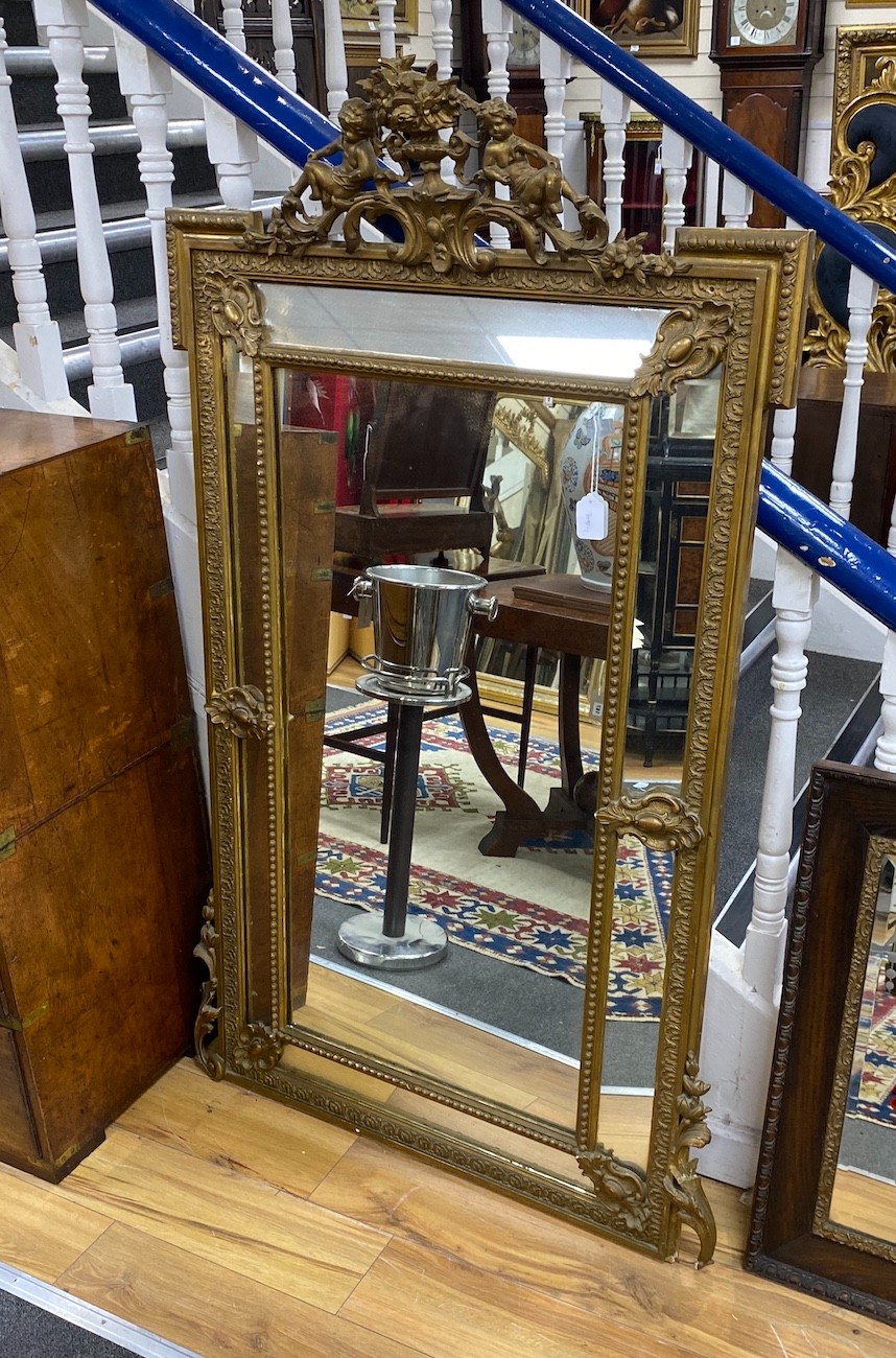 A French giltwood and composition overmantel mirror with floral cherub pediment width 91cm, height 157cm.